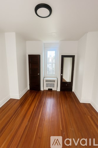 A room with wooden floors and white walls.