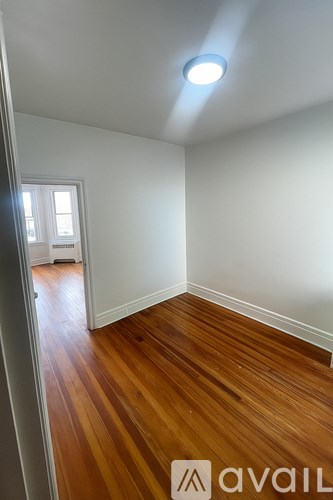 A room with wooden floors and a window.