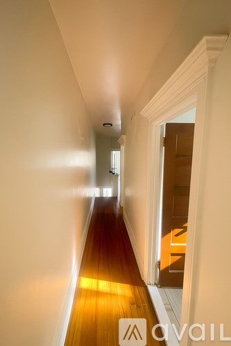 A long hallway with a light at the end.