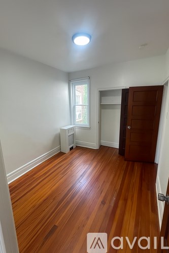 A room with wooden floors and a window.