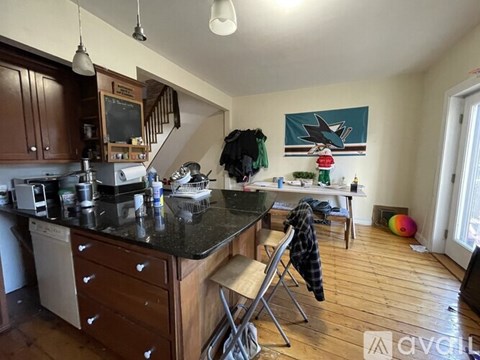 A kitchen with a black counter top and wooden cabinets.
