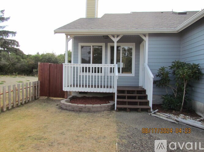 A house with a porch and a fence.