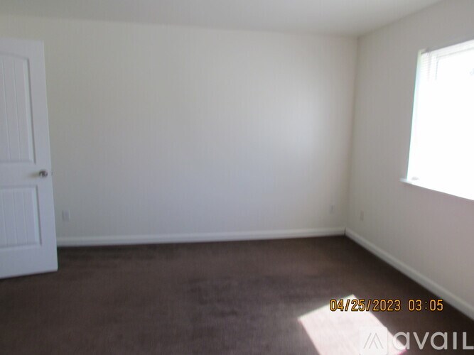 Empty room with a door and a window.