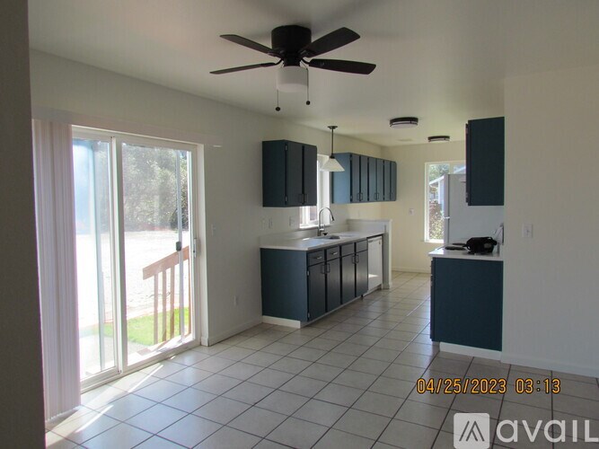 A kitchen with a ceiling fan and a date stamp.