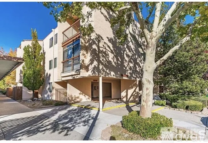 A building with a tree in front of it.