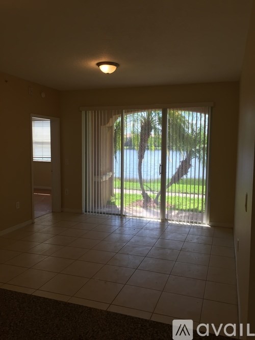 A room with a sliding glass door leading to a backyard.