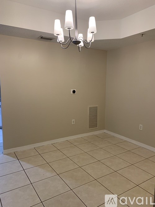 A room with beige walls and a tiled floor.