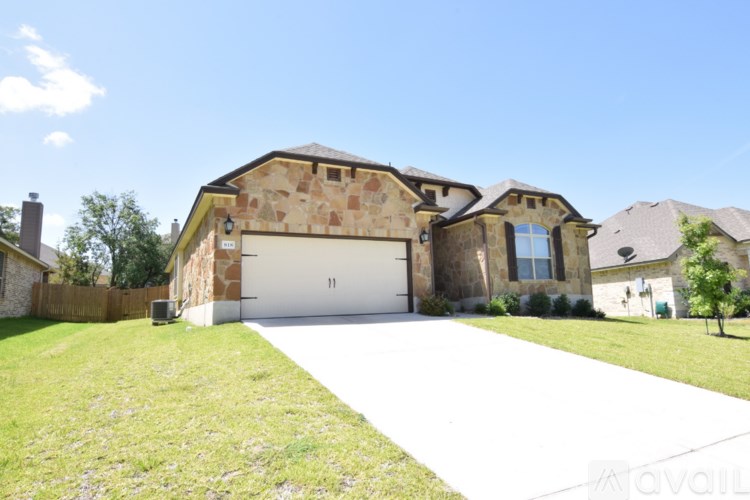 A house with a garage and driveway in front of it.