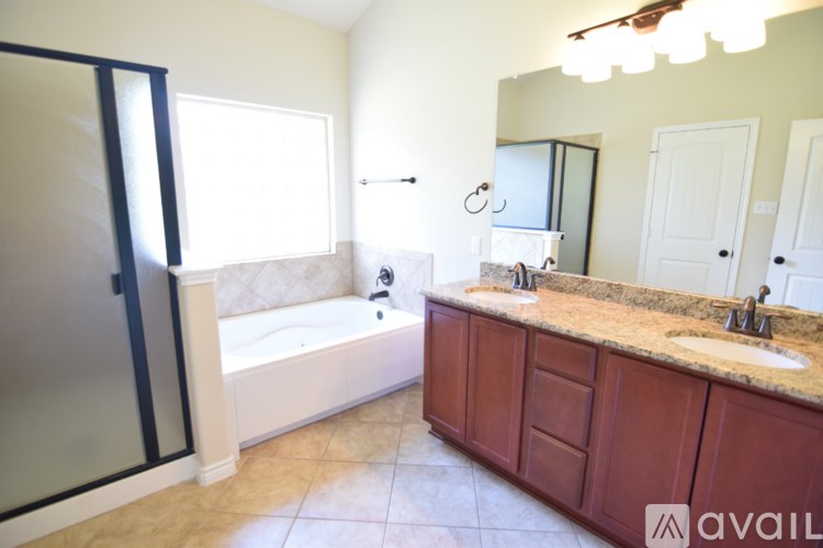 A bathroom with a tub, sink, and mirror.