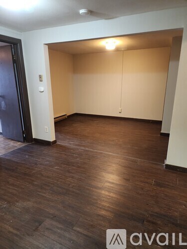 A room with wooden floors and a large open space.