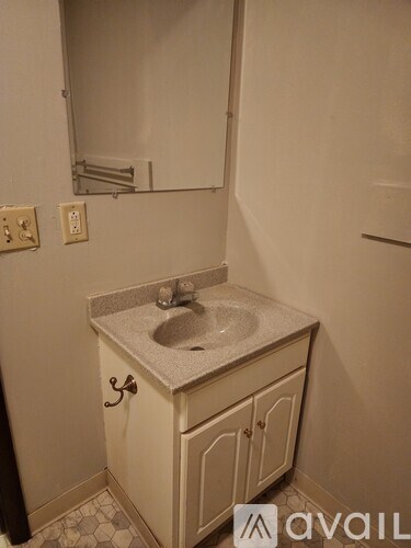 A bathroom with a sink and a mirror.