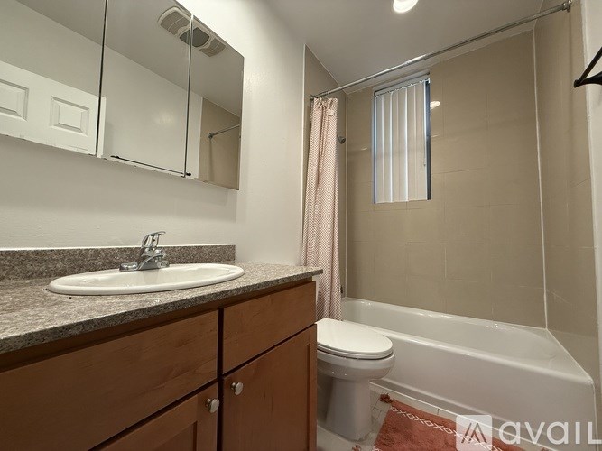 A bathroom with a sink, toilet, and bathtub.