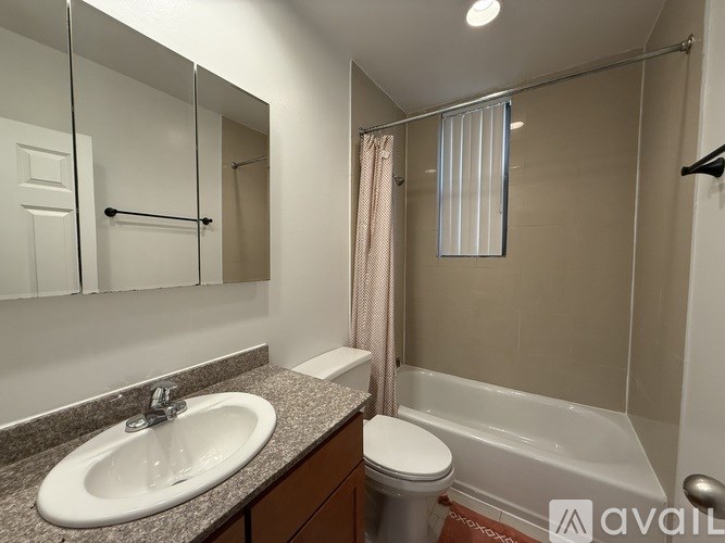 A bathroom with a sink, toilet, and bathtub.