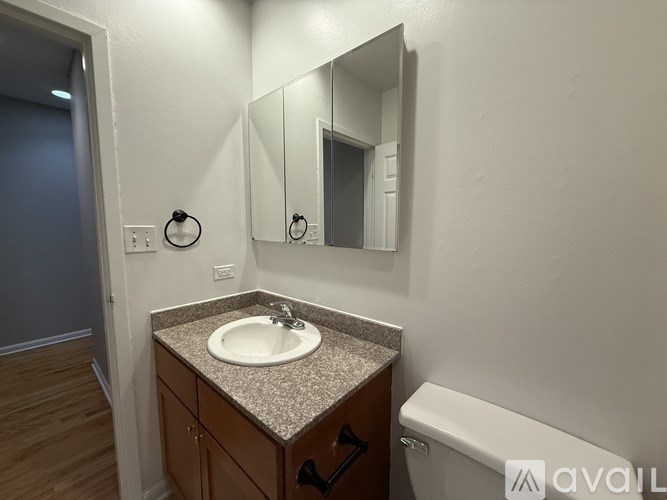 A bathroom with a sink, mirror, and toilet.
