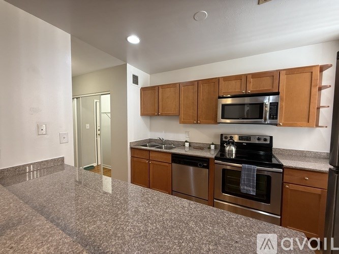 A kitchen with granite countertops and stainless steel appliances.