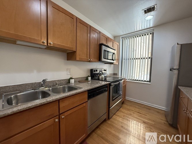 A kitchen with wooden cabinets and stainless steel appliances.