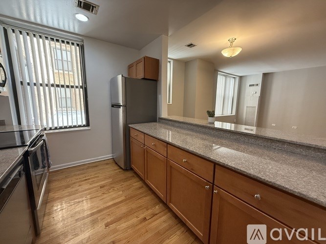 A kitchen with wooden cabinets and a granite countertop.