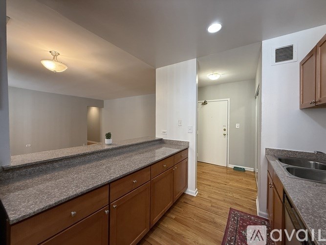 A kitchen with wooden cabinets and a granite countertop.