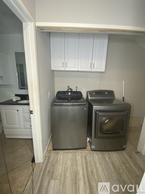 A small kitchen with a washing machine and a dishwasher.