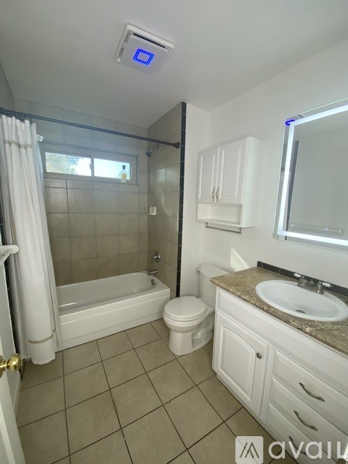 A bathroom with a toilet, sink, and bathtub.