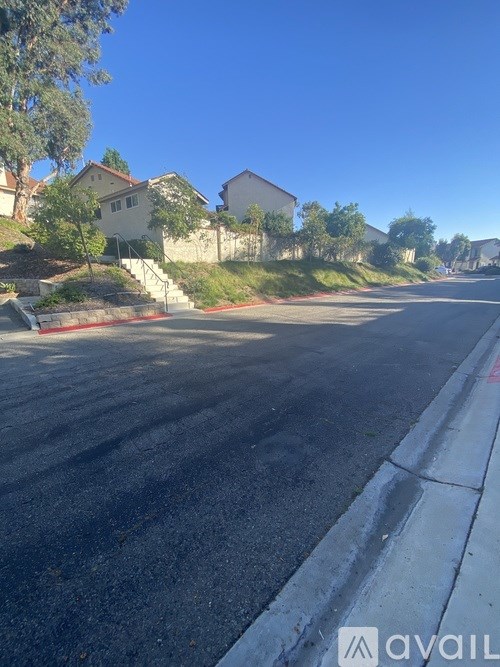 A street with houses on the side and a clear sky.