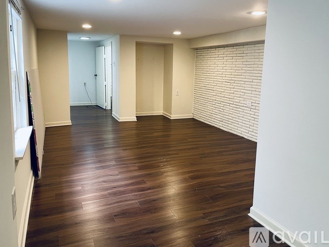 A room with wooden floors and white walls.