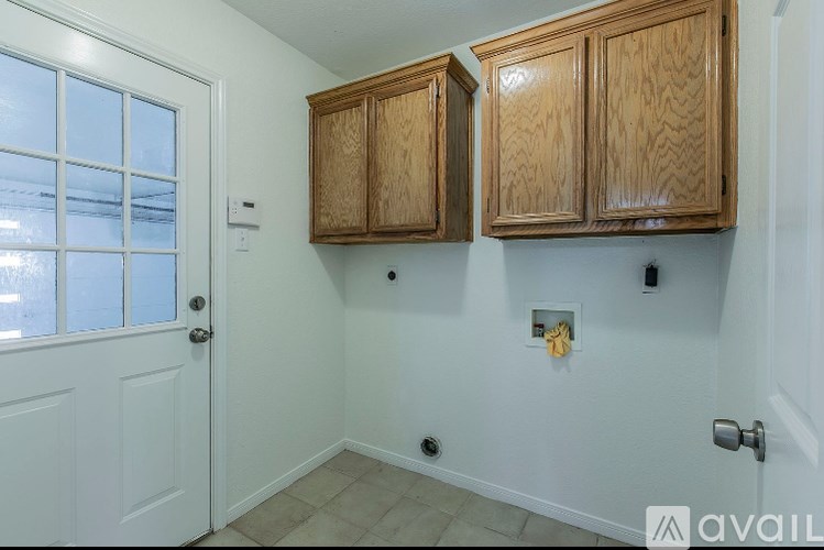 A room with wooden cabinets and a white door.