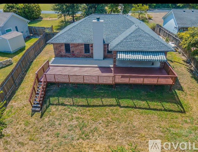 A house with a red brick chimney and a covered patio.