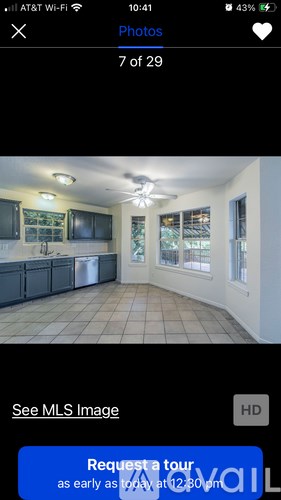 A kitchen with a blue sign that says "Request a tour as early as 12:00pm".