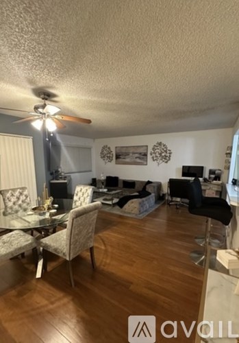 A living room with a dining table and chairs.