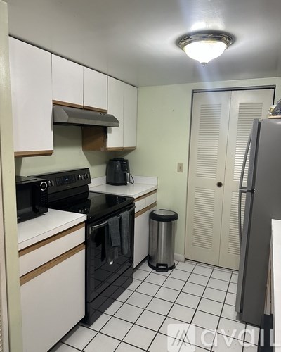 A living room with a grey couch and a glass coffee table.