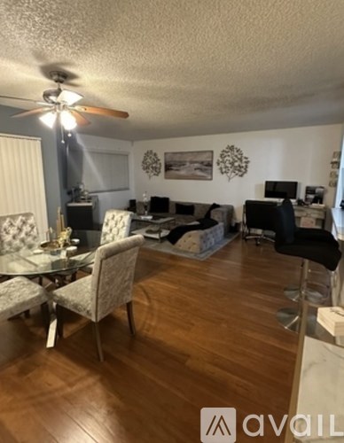 A living room with a dining table and chairs.