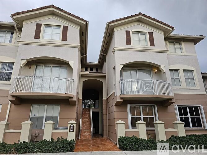A two-story apartment building with a balcony on the second floor.