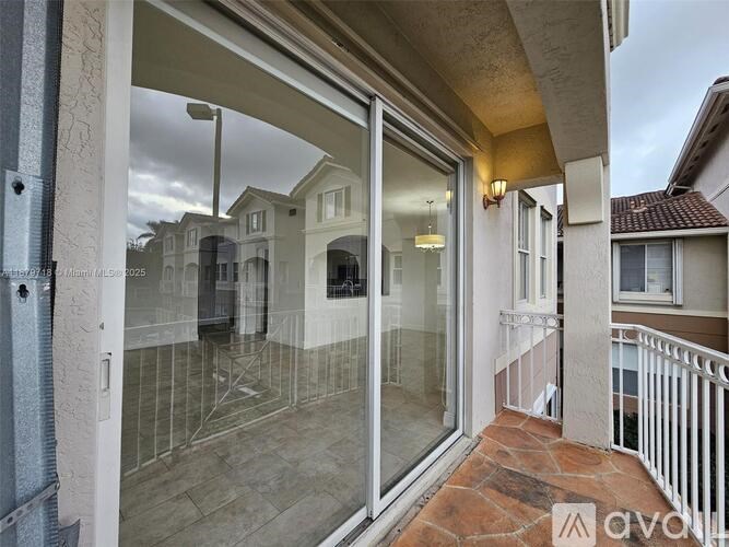 A balcony with a glass door and a metal railing.