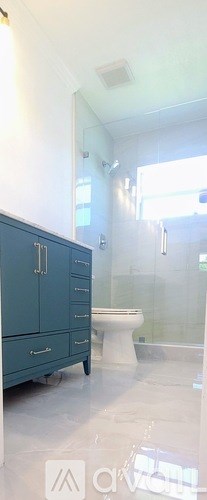 A bathroom with a toilet, sink, and shower.