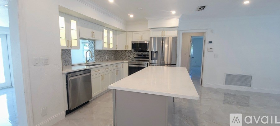 A modern kitchen with a large island in the middle.