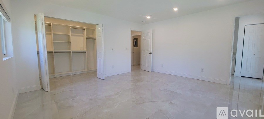 A large, empty room with a walk-in closet.