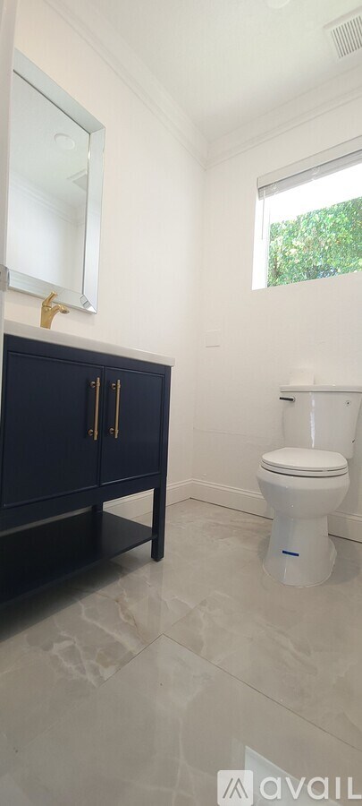 A bathroom with a toilet and a cabinet.