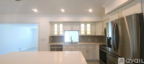 A kitchen with a refrigerator and a countertop.