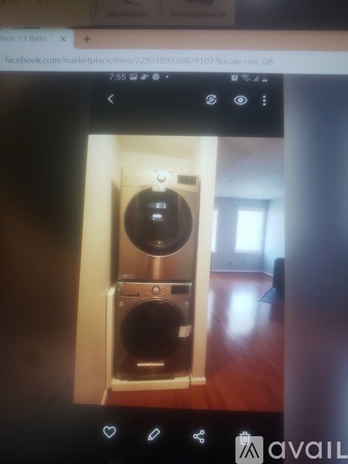 A washing machine is sitting in a small laundry room.