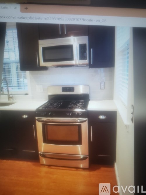 A modern kitchen with a stainless steel oven and microwave above it.