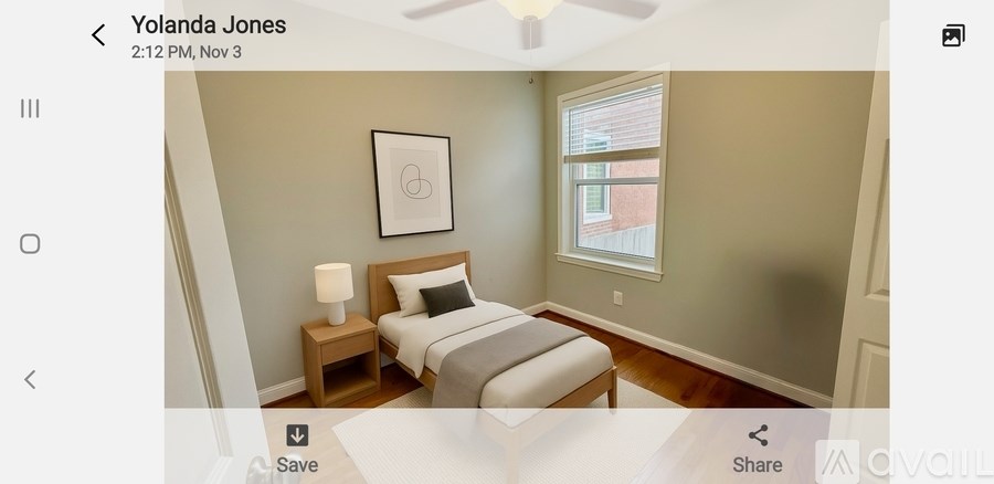 A bedroom with a bed, nightstand, and lamp.