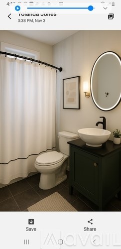 A bathroom with a toilet, sink, and shower curtain.