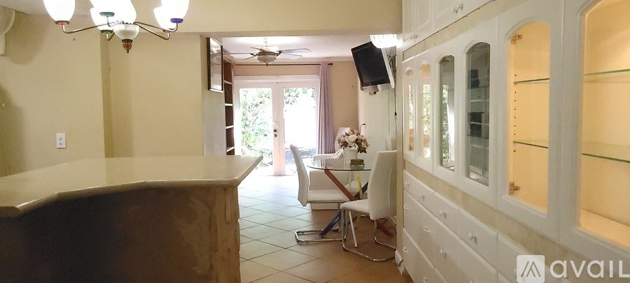 A kitchen with a counter and a chair.