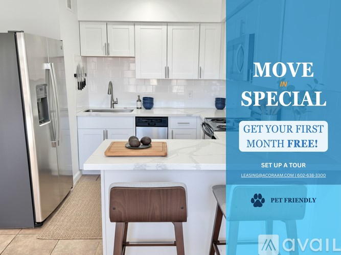 A kitchen with a refrigerator, sink, and a countertop with a cutting board and two stones on it.