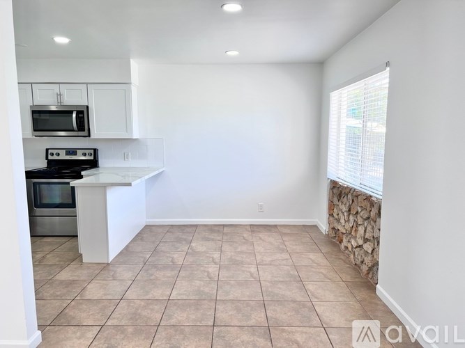 A kitchen with a stove top oven and microwave.