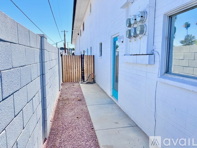 A white house with a blue door and a wooden fence.