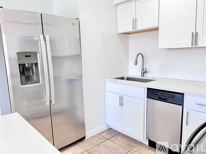 A kitchen with a stainless steel refrigerator and a dishwasher.