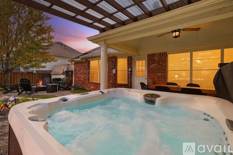 A hot tub is in the middle of a patio.