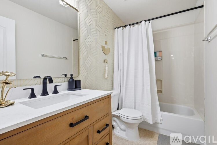 A bathroom with a white sink and a white toilet.